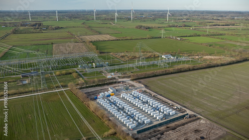 Grid-scale battery storage and substation in rural energy landscape. Large-scale battery energy storage system (BESS) installation within rural agricultural landscape. 