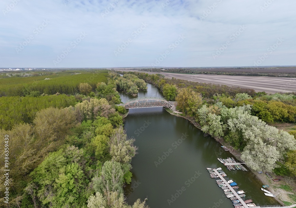 Fototapeta premium Aerial view of bridge over river oxbow with lush green landscape