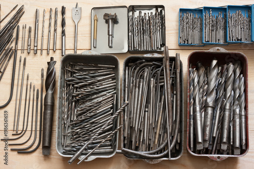 Drills and thread tap variety on wooden table