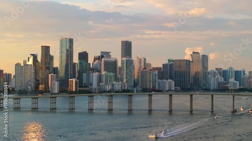 Downtown Brickell in Miami, Florida. William M Powell Bridge spanning across the bay with urban traffic and surrounding towers of glass and steel in vibrant financial district.