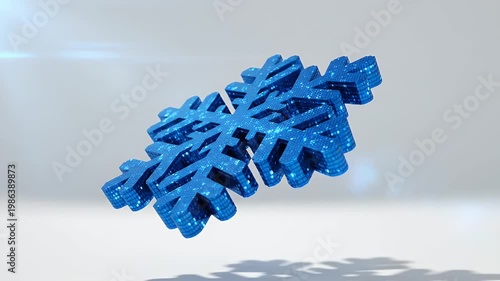 Blue translucent six-pointed snowflake ornament with geometric arms resting on a bright white surface