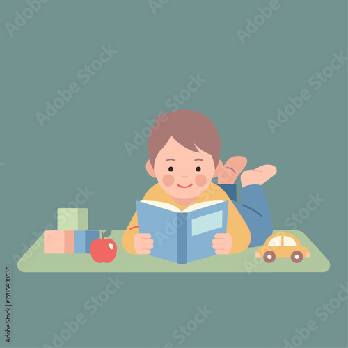 Boy reading a book happily lying down.