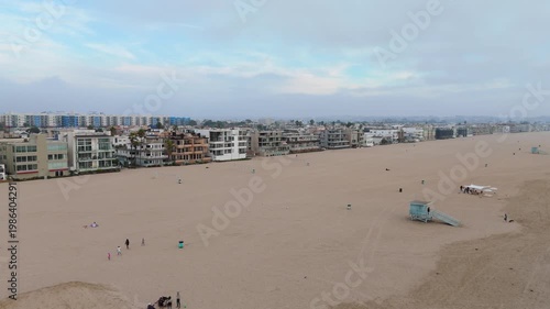 Aerial view of wide sandy beach and coastal residential buildings