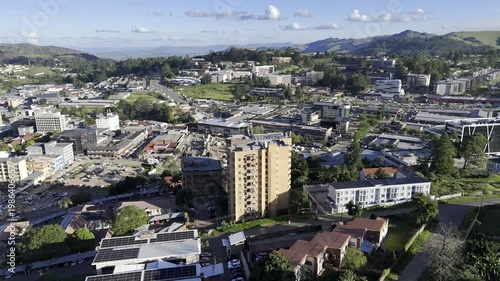 Drone flies east into the center of town in the late afternoon before sunset in mountain town of Mbabane, Eswatini