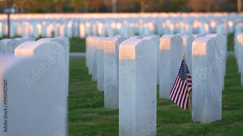 Sarasota National Cemetery with many white headstones and USA flag on green grass lawn. Memorial Day concept.
