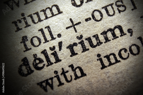 Photography Word delirium printed on dictionary page, macro close up