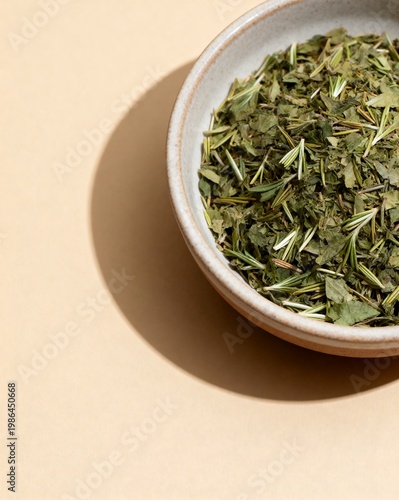 Bowl of Dried Green Herbs and Spices with Harsh Sunlight and Shadow