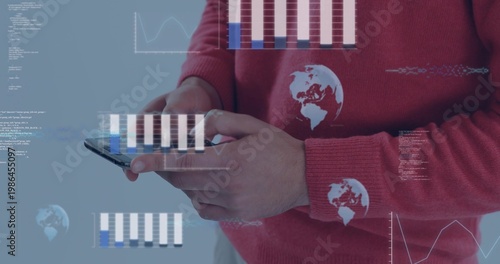 Holding phone hands wearing red sweater with white globes tapping screen at studio with data charts