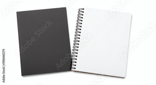 A spiral-bound notebook with a black and white cover on a plain white background