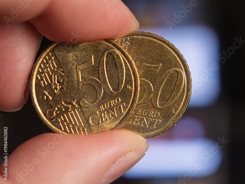 Coins in Hand: Close-Up of 50 Euro Cents