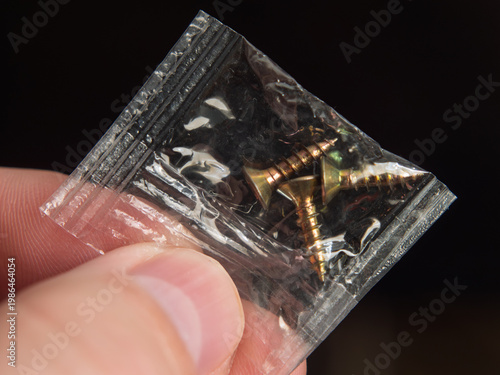  Close-Up of Gold Screws in Plastic Packaging