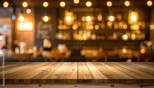 Empty wood table top on blur light gold bokeh of cafe restaurant in dark background
