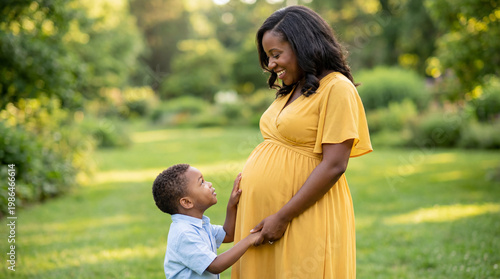 Mother's Day expectant mother with toddler son outdoors holding hands showing sibling anticipation joy for lifestyle magazine editorial photography