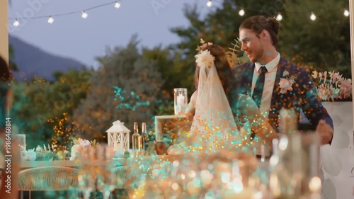 Groom leading bride from table, spinning dipping while teal sparks overlay couple for wedding