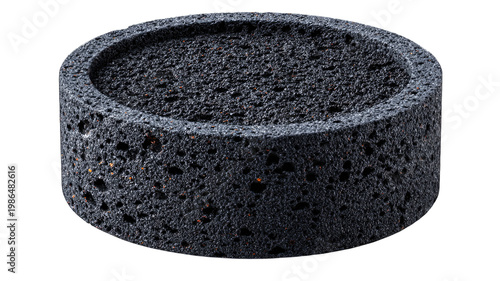 A dark cylindrical porous object resembling lava rock with a textured surface isolated on transparent background