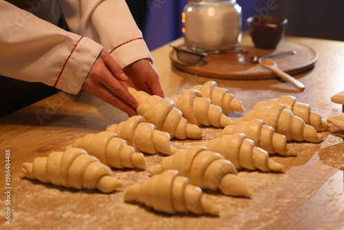 Female baker making croissa...