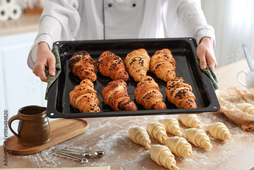 Female baker holding baking...
