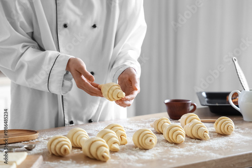 Female baker making croissa...