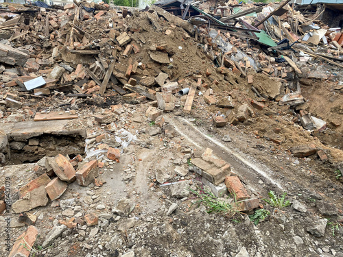 Fotografie A large pile of rubble in a residential area, dismantling or demolishing old hou