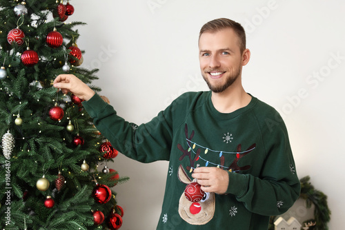 Young man in sweater decora...