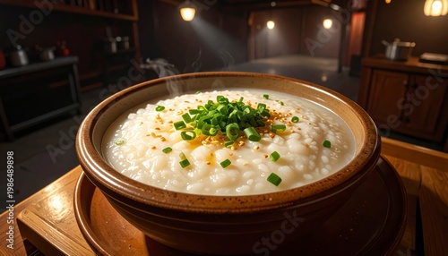 Steaming bowl of congee rice porridge topped with fresh green scallions and sesame seeds in a rustic bowl