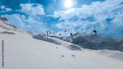 Tableau sur toile Ski lift over pristine snowy mountains with blue sky and clouds in Andes winter travel destination