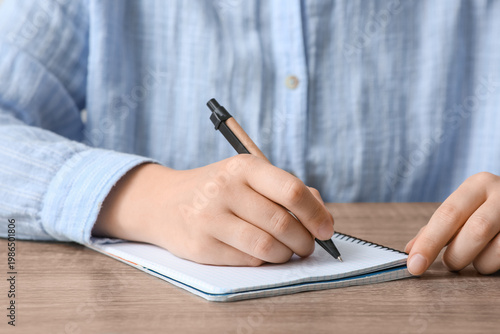 Woman writing something in ...
