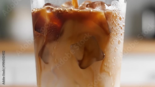 Wallpaper Mural Pouring iced coffee into a glass with milk and ice Torontodigital.ca