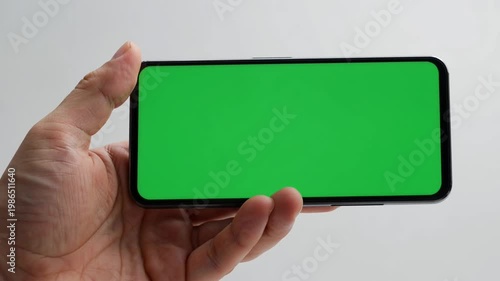 Smartphone with green screen hand interaction on white background