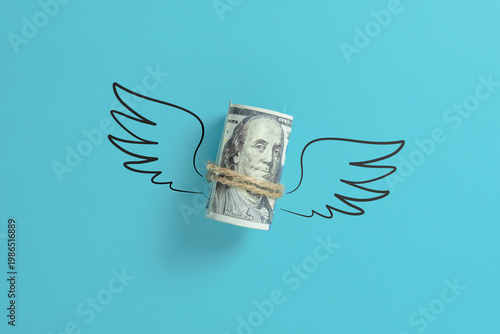 Photos Roll of us dollar money with wings.