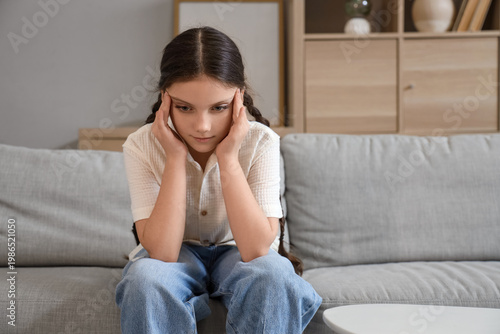 Cute girl suffering from he...