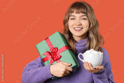 Pretty young woman holding ...