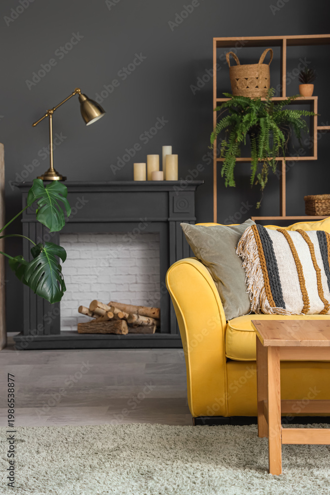 Fototapeta premium Interior of living room with decorative mantelpiece and sofa