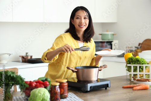 Young Asian woman cooking d...