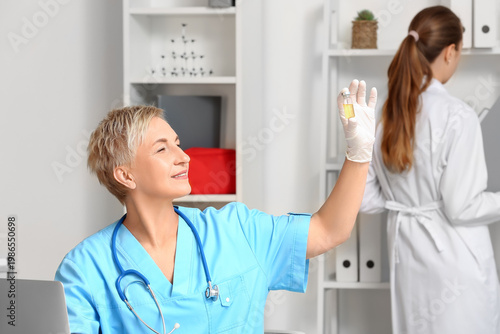 Female doctor with ampule i...