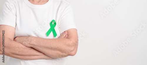 Schilderij op canvas Elderly with Green Ribbon for concept of April Donate Life month, Organ Donation and Transplant Awareness, May Mental Health Awareness month and October Liver cancer