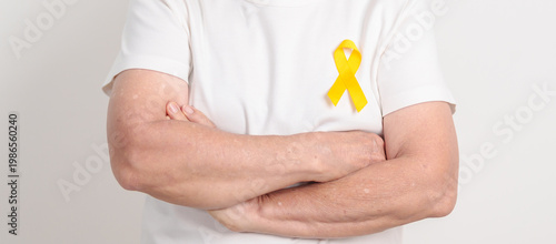 Cuadro en lienzo Elderly with Yellow Ribbon for concept of yellow September, Suicide prevention day, Childhood, Pediatric, May Missing Children Awareness day month, support survivor