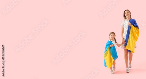 Going little girl and her mother with Ukrainian flags on pink background with...