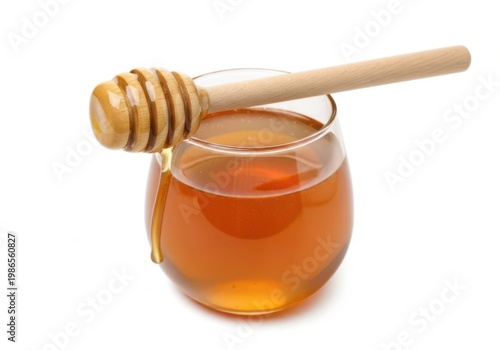 Golden honey in a glass jar with a wooden dipper dripping down