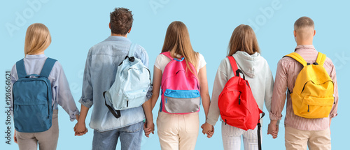 Group of students with backpacks on blue background