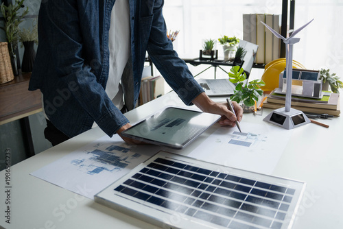 Engineer Design green energy technology with solar panel and wind turbine