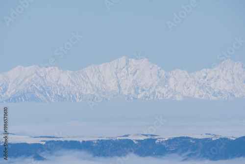 The snow-capped Japanese Alps as seen from Mount Yatsugatake