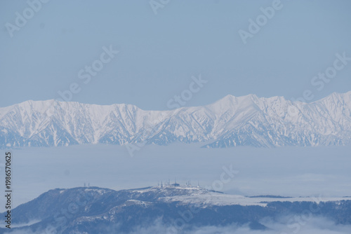 The snow-capped Japanese Alps as seen from Mount Yatsugatake