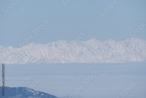 The snow-capped Japanese Alps as seen from Mount Yatsugatake
