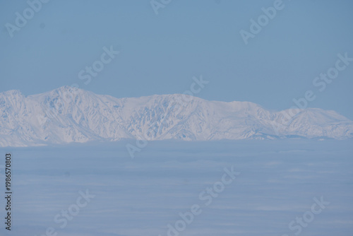 The snow-capped Japanese Alps as seen from Mount Yatsugatake