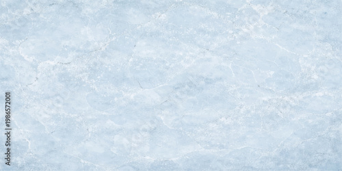 An abstract winter background featuring a bright blue ice texture with frozen snowflakes and frost patterns on a window pane capturing the cold essence of the nature season