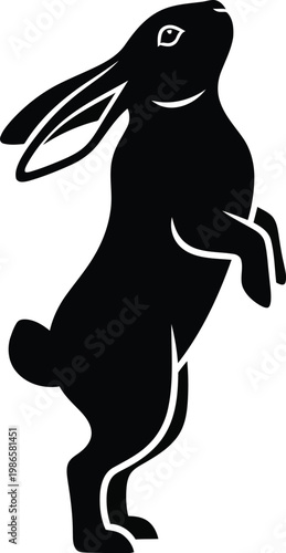 black silhouette of a rabbit standing on hind legs looking up