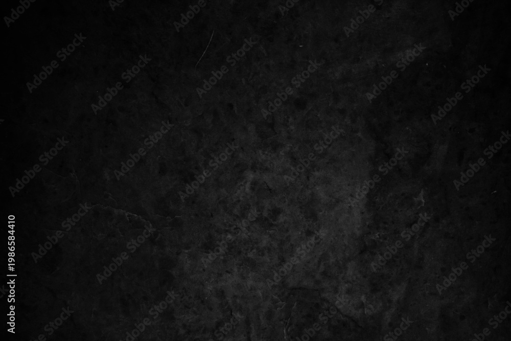 Fototapeta premium Dark, textured background with a rough, stone-like appearance in shades of black and gray