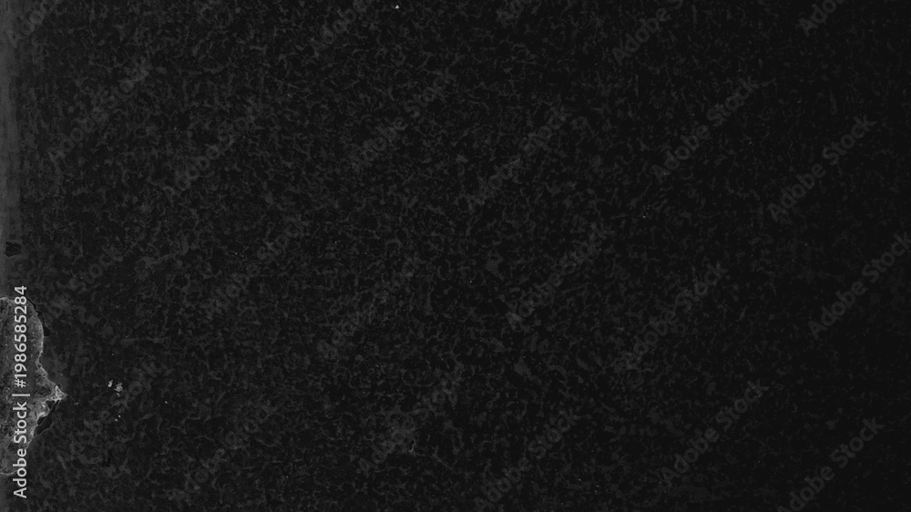 Fototapeta premium Dark textured desktop wallpaper with a rough, grainy surface and subtle light patches