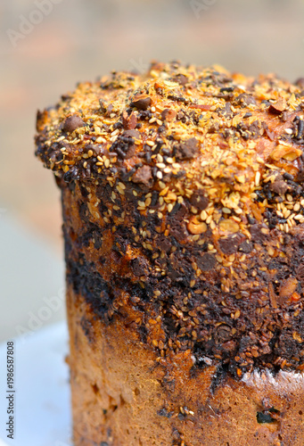 Traditional Easter cake decorated with chocolate chips, sesame seeds and sliced almonds.